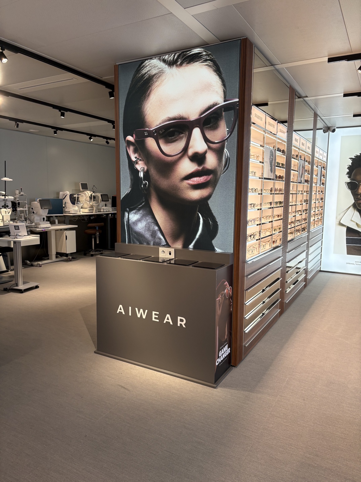 Meuble de présentation AIWEAR devant un visuel Ray-Ban Meta en magasin